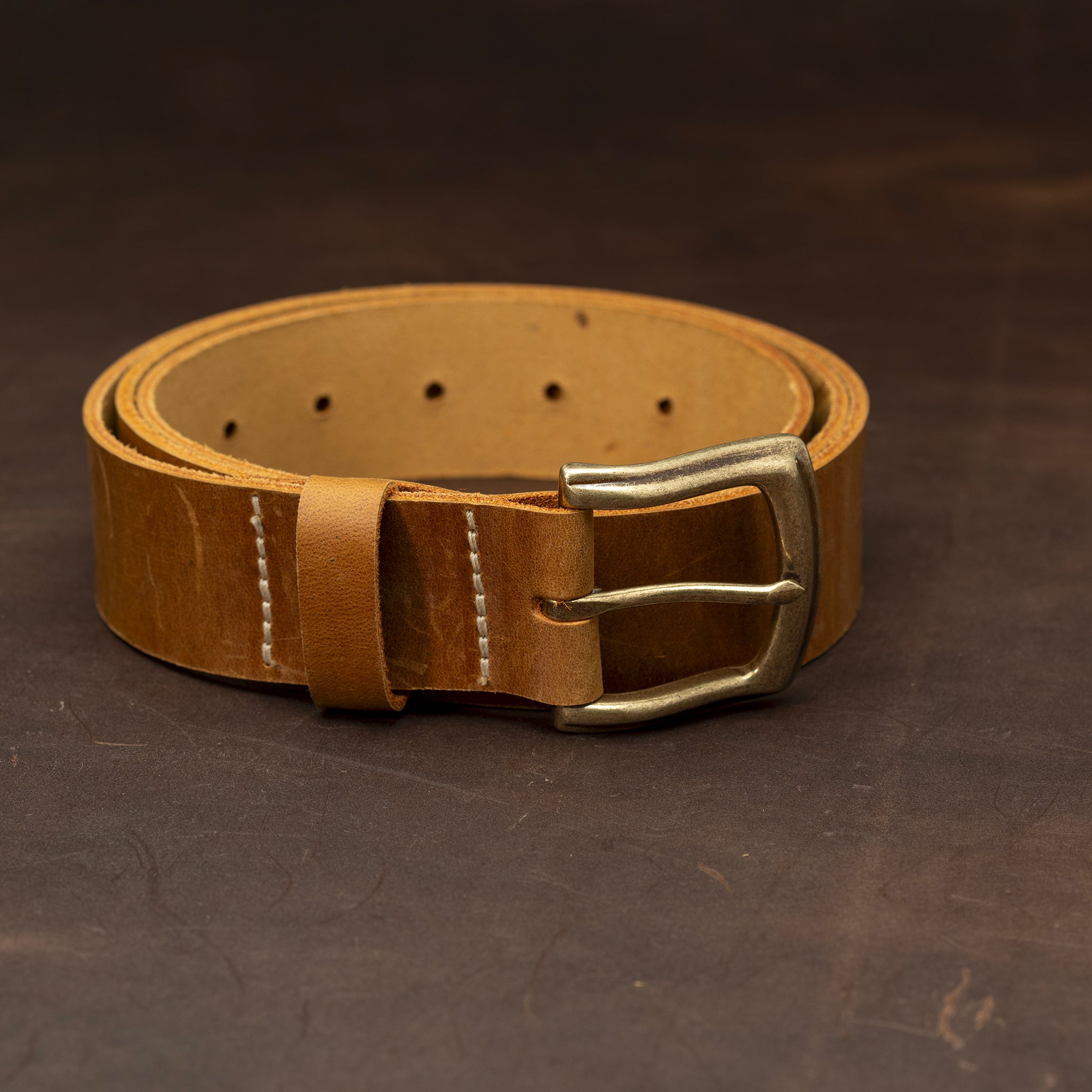 Light brown leather belt with a brass buckle