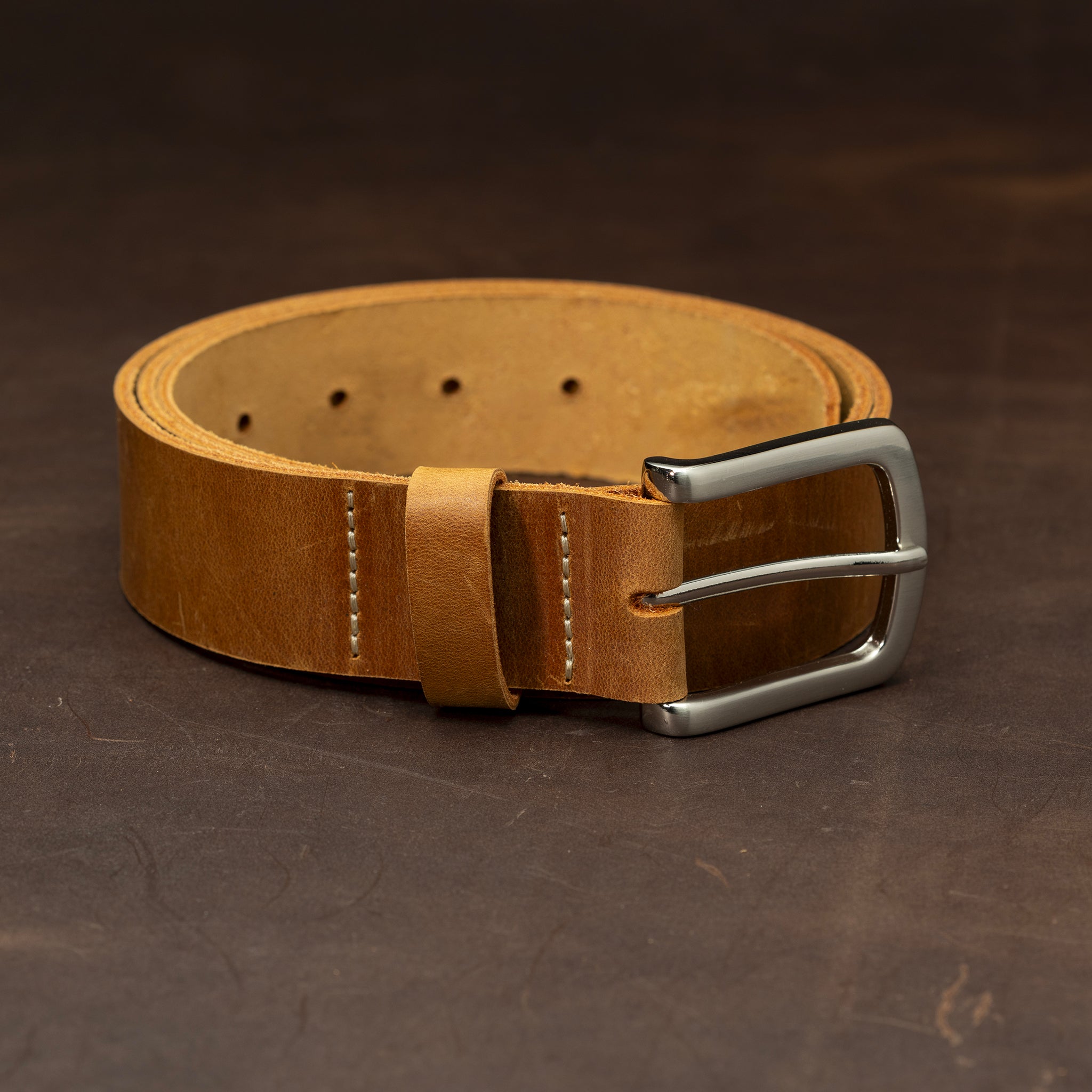 Light brown leather with nickel buckle