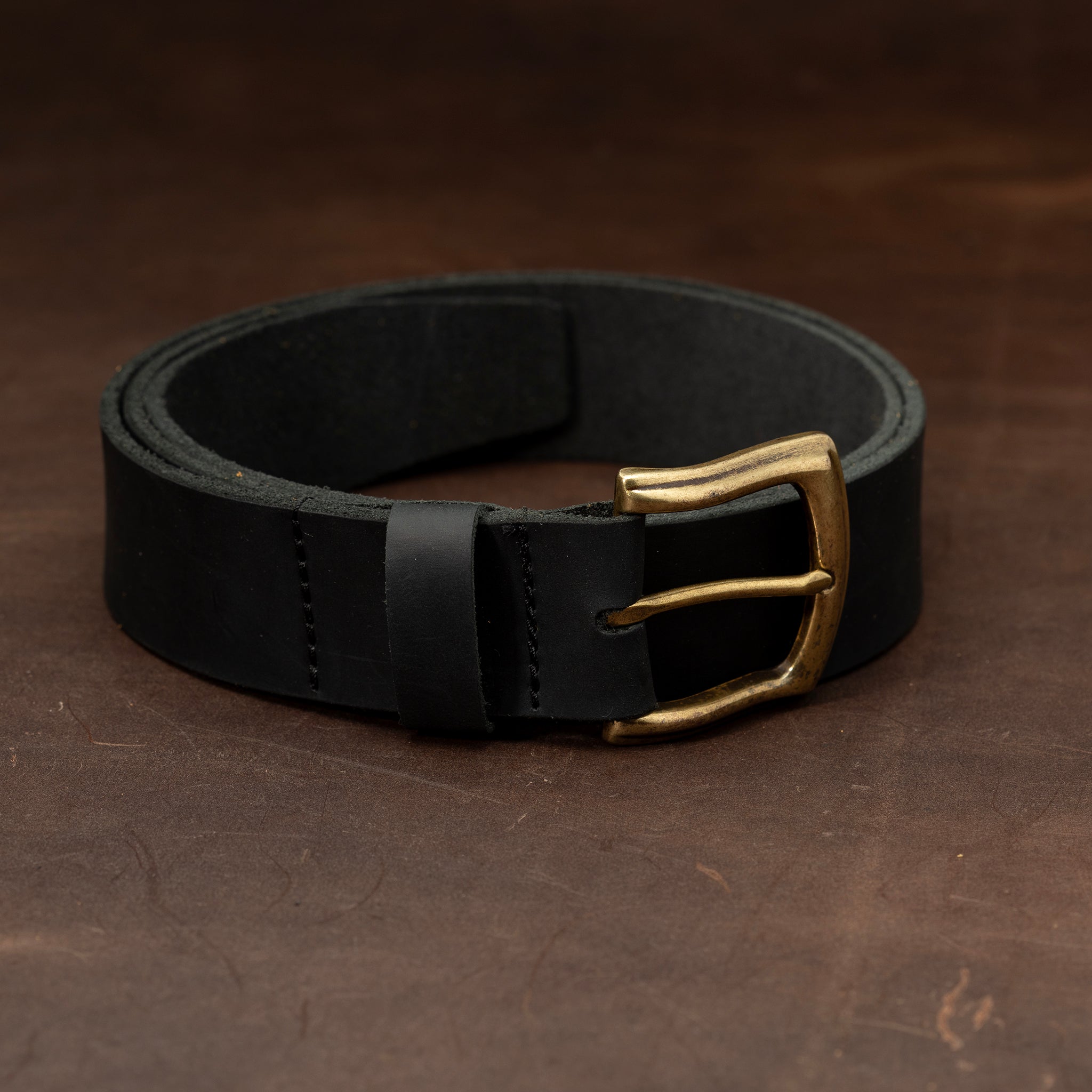 Black leather belt with brass buckle