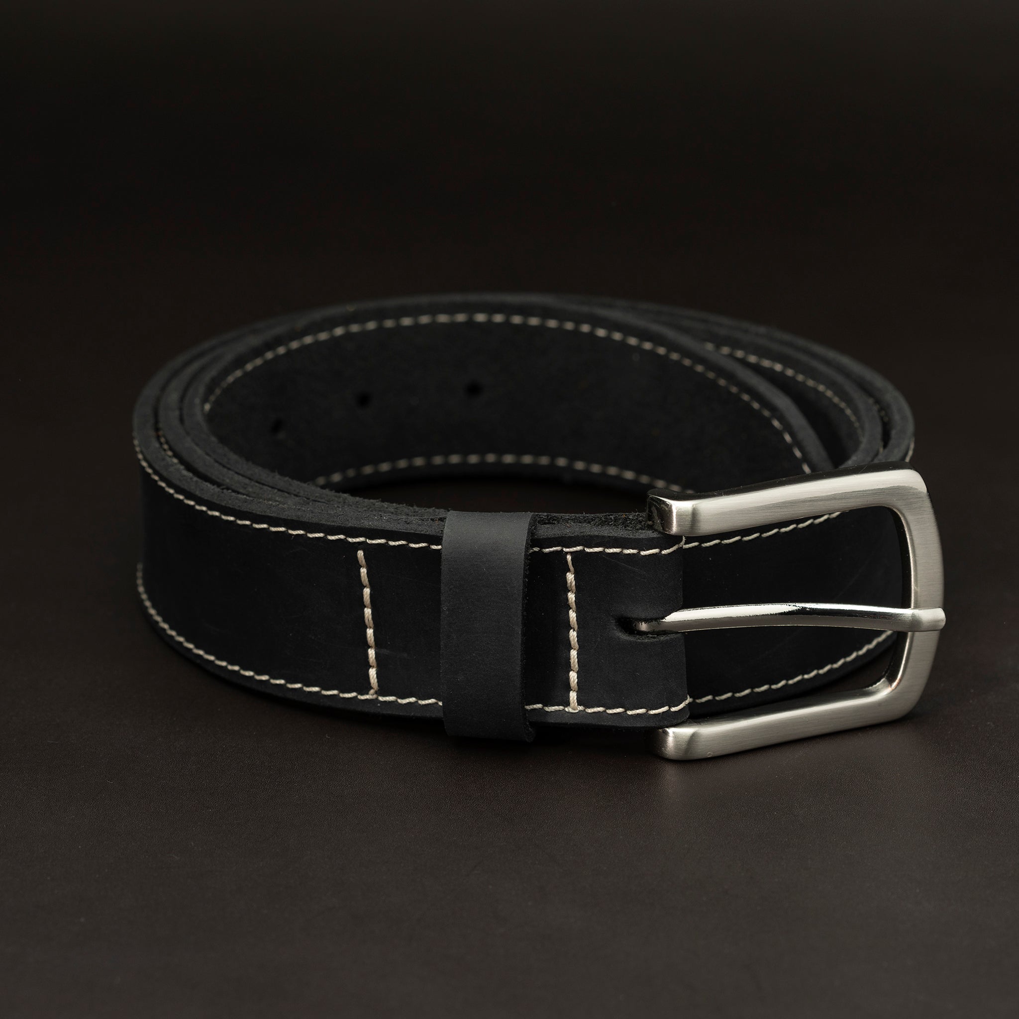 Black leather belt with nickel buckle and light stitching